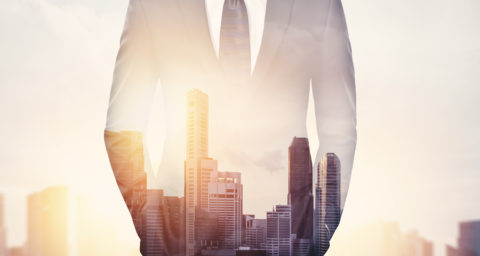 transparent business man with cityscape showing through him