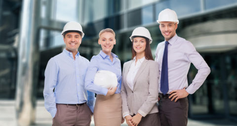 business men and women with hard hats