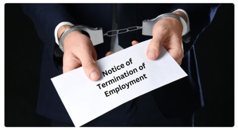 business person handcuffed turning in notice of termination of employment