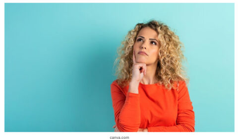 woman in orange shirt thinking