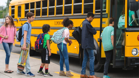 back to school kids getting on bus